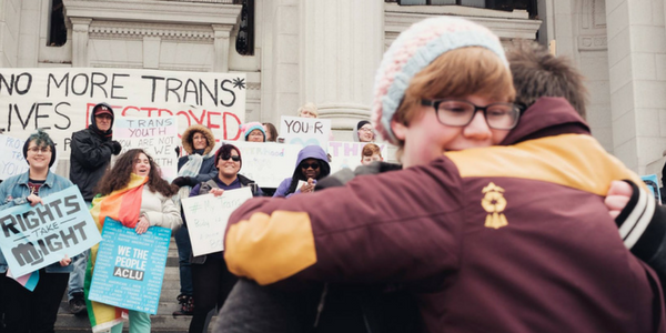 LGBTQ youth hug at a rally to support trans youth in Hartford, Connecticut with the ACLU-CT