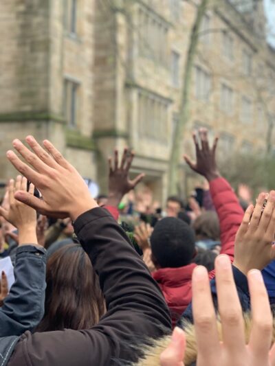 Protesters in New Haven stand in "hands up don't shoot" position protesting Hamden and Yale police shooting of Stephanie Washington and Paul Witherspoon