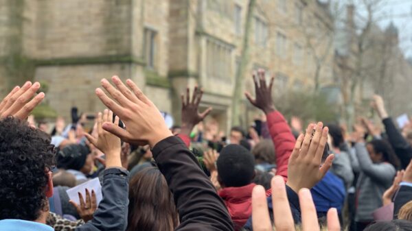 Protesters in New Haven stand in "hands up don't shoot" position protesting Hamden and Yale police shooting of Stephanie Washington and Paul Witherspoon