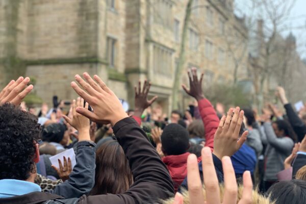 Protesters in New Haven stand in "hands up don't shoot" position protesting Hamden and Yale police shooting of Stephanie Washington and Paul Witherspoon