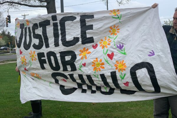 Protesters in Wethersfield hold a "justice for chulo" banner demanding justice for Anthony "Chulo" Vega, who was shot and killed by Wethersfield police