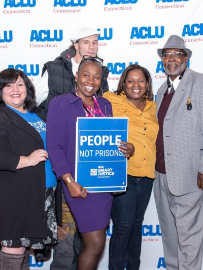 ACLU-CT Smart Justice leaders and Rep. Robyn Porter stand in front of an ACLU of Connecticut banner at the "Smart Justice: Year One" film premiere in New Haven