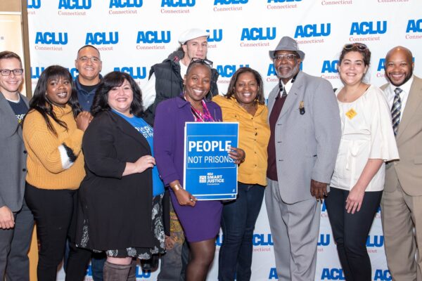 ACLU-CT Smart Justice leaders and Rep. Robyn Porter stand in front of an ACLU of Connecticut banner at the "Smart Justice: Year One" film premiere in New Haven