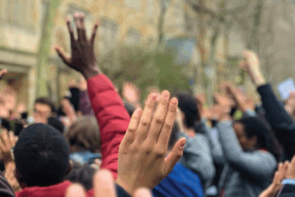 ACLU of Connecticut 2019 Annual Report cover shows, from behind, a crowd of people in "hands up, don't shoot" position. "2019 annual report" appears at the top, with the ACLU of Connecticut logo in white at the bottom