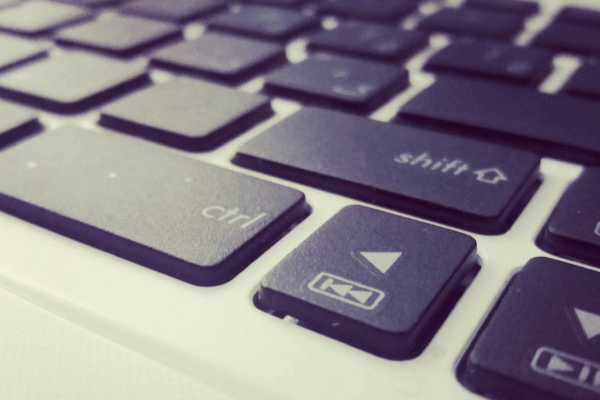 Black and white photo of a keyboard, focus on control, shift, and arrow buttons