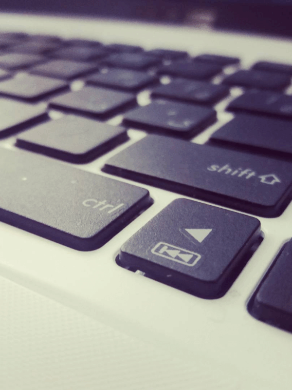 Black and white photo of a keyboard, focus on control, shift, and arrow buttons
