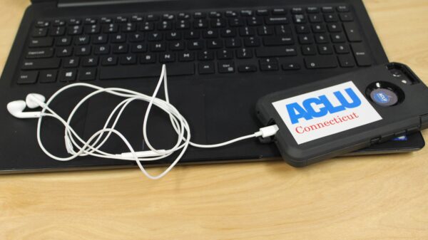 ACLU of Connecticut photo of laptop, phone, headphones with an ACLU of Connecticut sticker