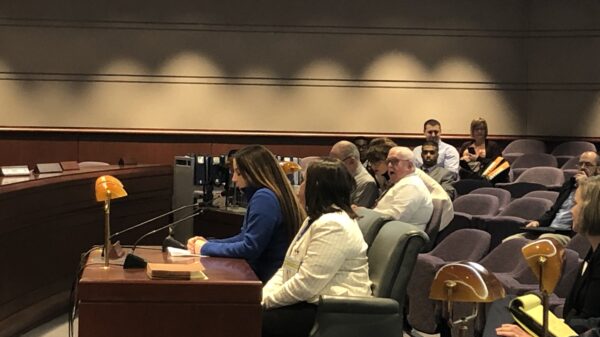 Ciara Rosati, Smart Justice leader, testifies in support of strong Clean Slate, SB 403, at the CT General Assembly in 2020. Ciara wears a blue shirt and is seated next to policy counsel Kelly Moore, in a white blazer.