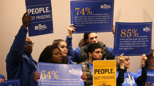 ACLU-CT Smart Justice leaders stand with "people not prisons" posters at a Connecticut Clean Slate pres conference