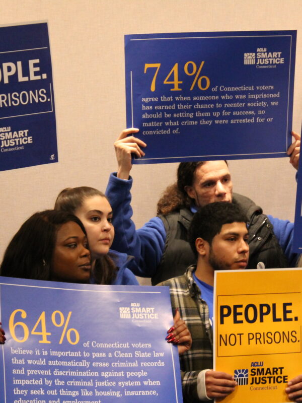 ACLU-CT Smart Justice leaders stand with "people not prisons" posters at a Connecticut Clean Slate pres conference