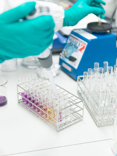 beakers and lab technician hands