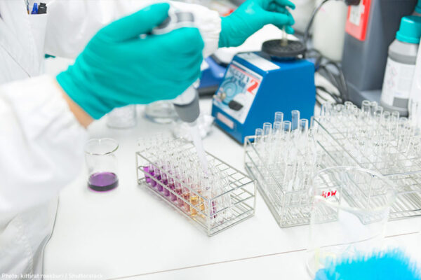 beakers and lab technician hands