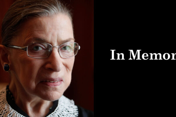 A close up photo of Supreme Court Justice Ruth Bader Ginsburg is on the left. She is looking directly at the camera. On the right, a black box. In the box, "in memory" is written in white letters.