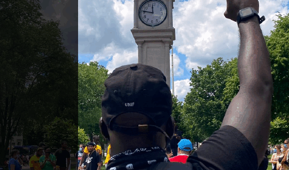Right, foreground: a Black man in a baseball hat stands with fist up in front of the clocktower in Waterbury. Left, against a black banner, in white, says: "2020 annual report." The ACLU of Connecticut logo is at the bottom left corner.