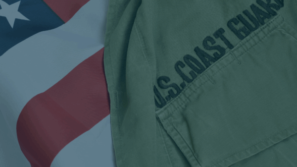 On the right, part of a U.S. Coast Guard uniform is visible, with "U.S. Coast Guard" stitching prominent. On the left and behind the uniform is the U.S.A. flag