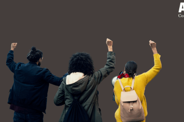 three people stand, fists raised in protest, against a gray background. A white ACLU of Connecticut logo is in the top right corner.