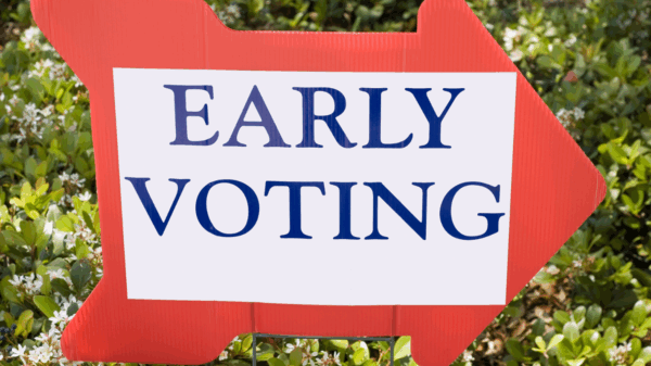 Red arrow right facing right that says early voting in blue font with a white background