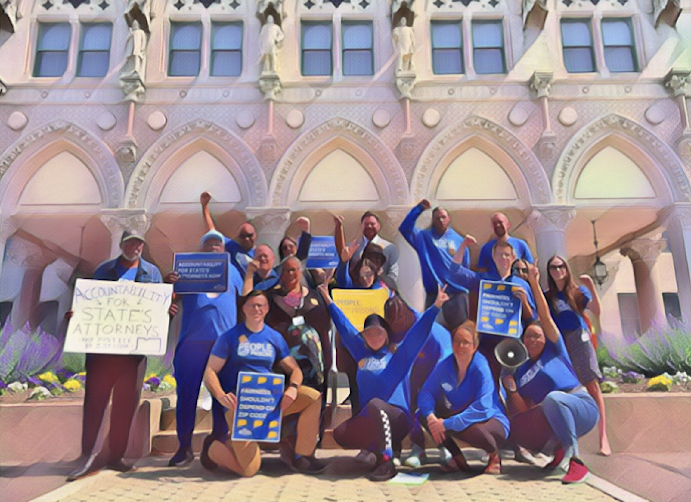Smart Justice leaders are smiling at the camera in front of the Capitol building with signs that promote prosecutorial accountability.
