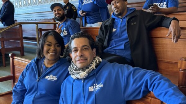In the Senate room, five of our Smart Justice leaders are sitting together and smiling at the camera with their Smart Justice blue apparel.