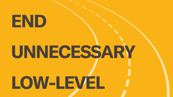 On a yellow background, a translucent image of road lines runs through the middle of the image. In gray text, in the center, appears: “End unnecessary low-level traffic stops.”