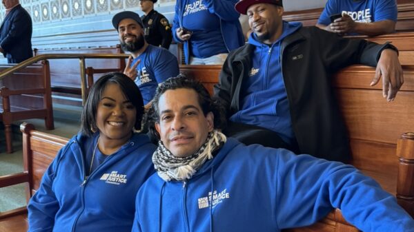Six Smart Justice leaders sit in the senate room smiling at the camera.