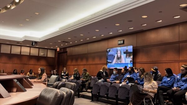 Jess, policy counsel, sits in front of the housing committee testifying in support of HB5242 with Smart Justice leaders behind her.