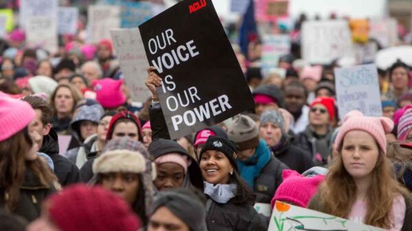 In a crowd of people at the Women's March, the focal point is on one black sign that reads in white, "Our Voice is Our Power."