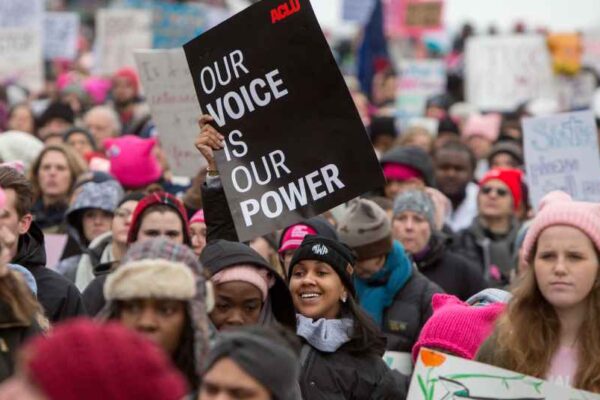 In a crowd of people at the Women's March, the focal point is on one black sign that reads in white, "Our Voice is Our Power."