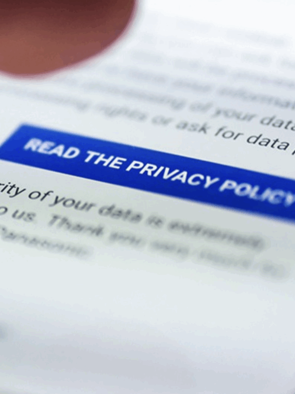 On a phone screen, there is a blur on everything except a blue button on the screen that says "READ THE PRIVACY POLICY."