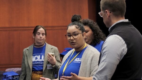 Our policy team (Gus, Chelsea-Infinity, and Jess) are standing in front of a crowd before advocacy day.