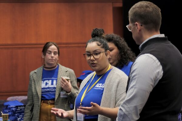 Our policy team (Gus, Chelsea-Infinity, and Jess) are standing in front of a crowd before advocacy day.