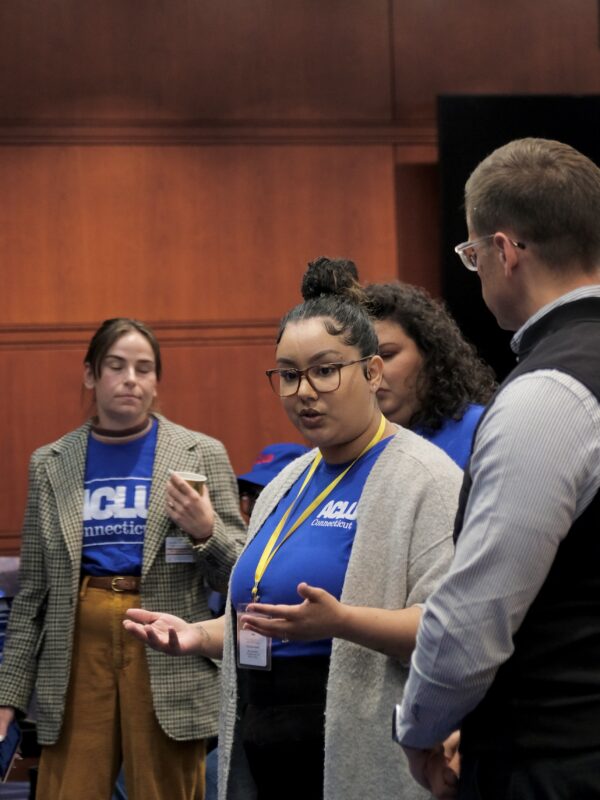 Our policy team (Gus, Chelsea-Infinity, and Jess) are standing in front of a crowd before advocacy day.