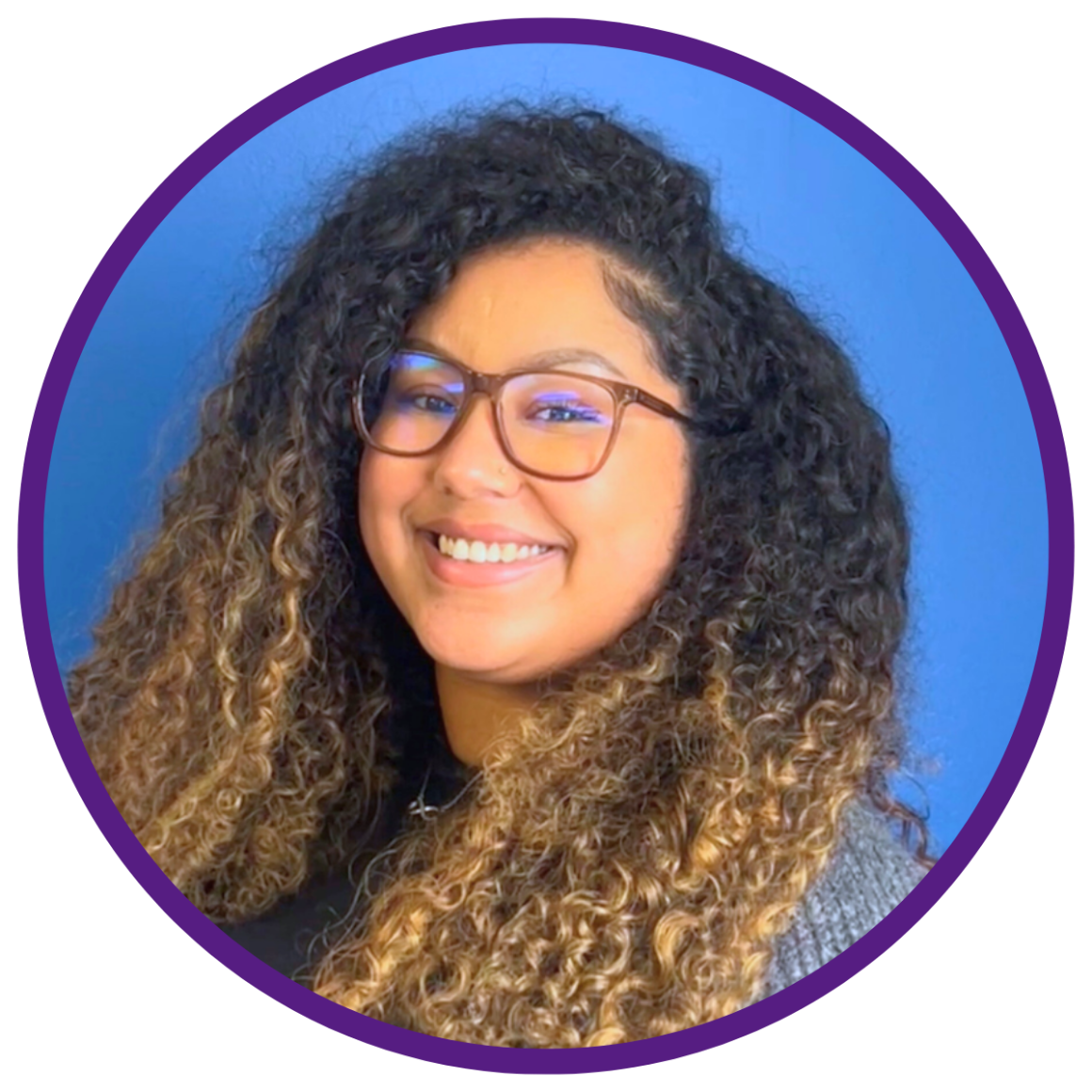 Chelsea-Infinity, our policy director, is smiling at the camera in front of a blue background that is cropped into a circle with a purple ring around the image.