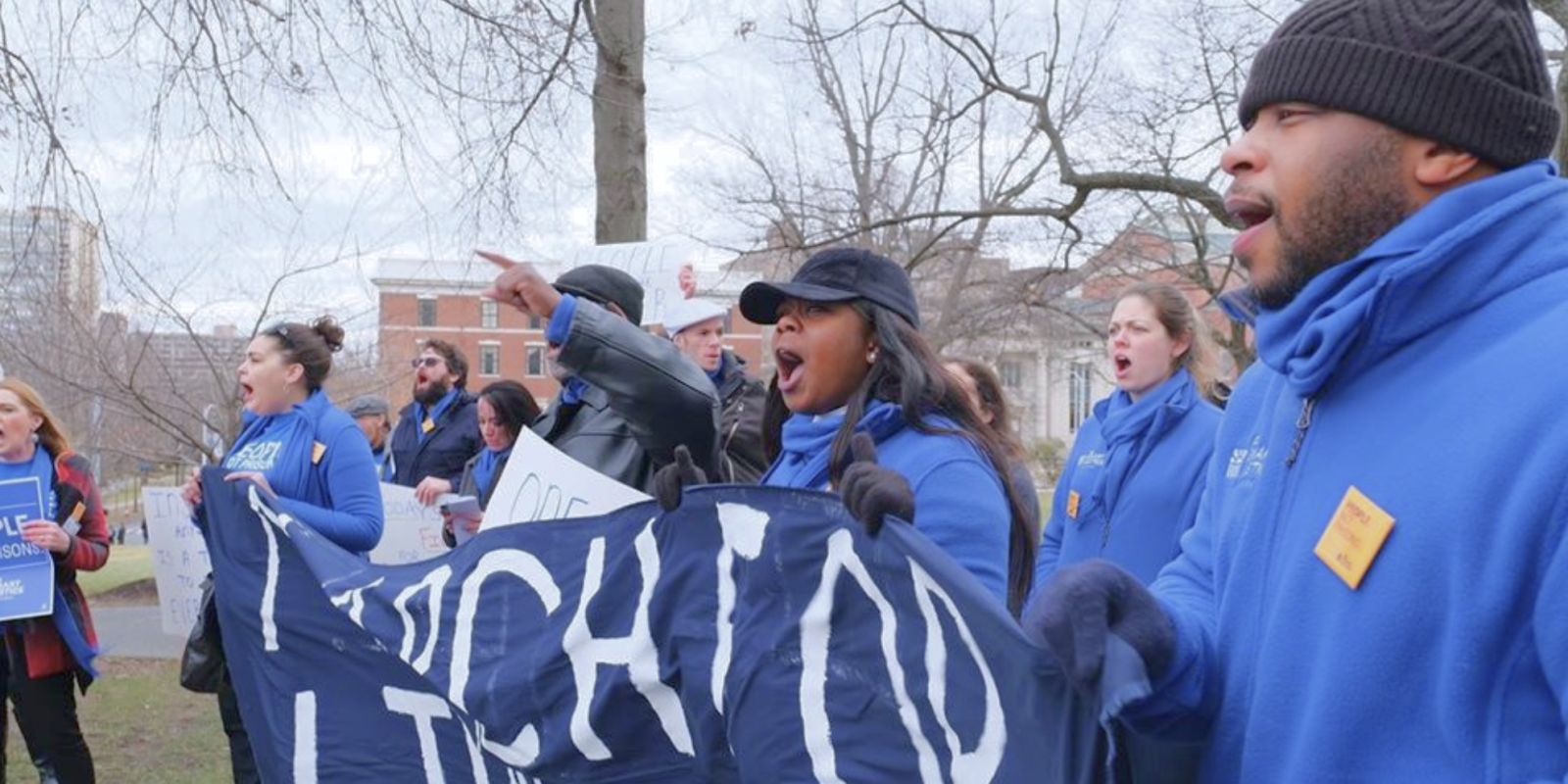 A group of Smart Justice leaders are holding a "March for Liberation" banner as they walk past the camera.