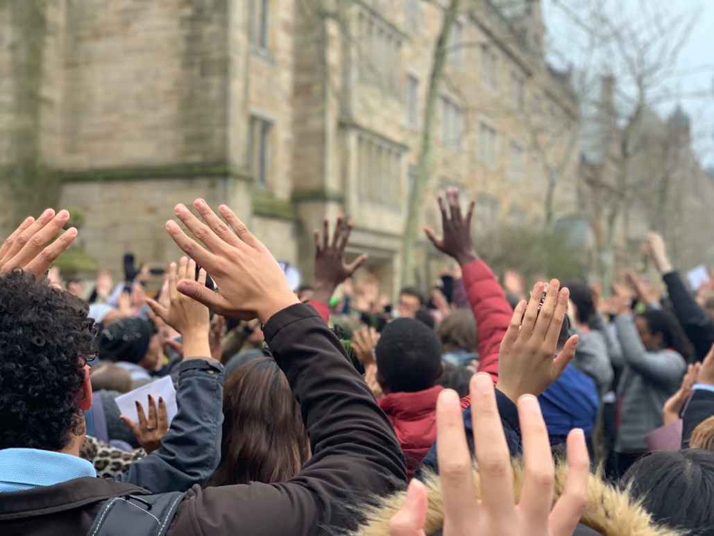 Protesters in New Haven stand in "hands up don't shoot" position protesting Hamden and Yale police shooting of Stephanie Washington and Paul Witherspoon