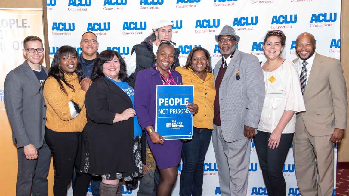 ACLU-CT Smart Justice leaders and Rep. Robyn Porter stand in front of an ACLU of Connecticut banner at the "Smart Justice: Year One" film premiere in New Haven