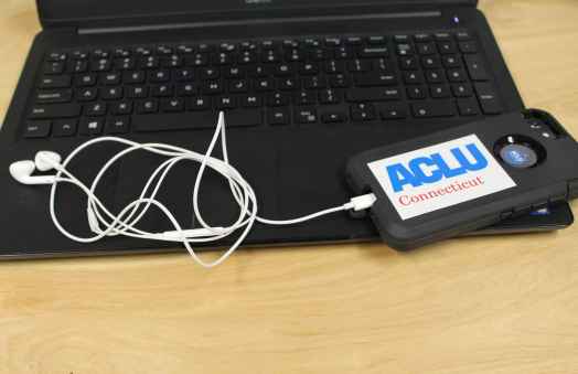 ACLU of Connecticut photo of laptop, phone, headphones with an ACLU of Connecticut sticker