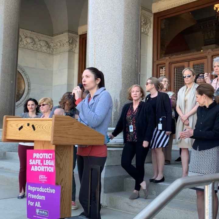 ACLU-CT speaks at abortion access rally in Hartford. Signs say "abortion is healthcare, abortion is a right" and "protect safe, legal abortion."
