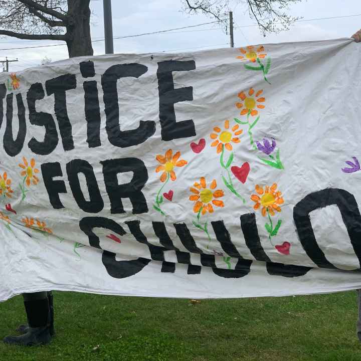Protesters in Wethersfield hold a "justice for chulo" banner demanding justice for Anthony "Chulo" Vega, who was shot and killed by Wethersfield police