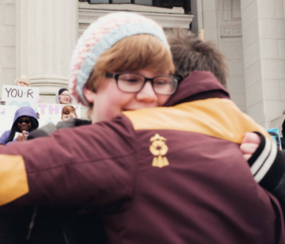 LGBTQ youth hug at a rally to support trans youth in Hartford, Connecticut with the ACLU-CT