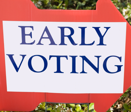 Red arrow right facing right that says early voting in blue font with a white background