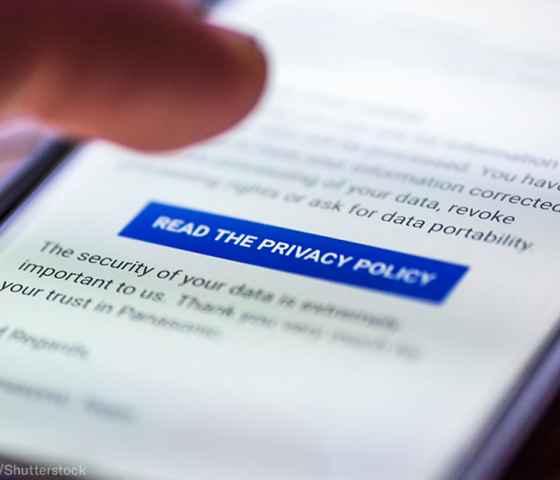 On an iphone screen, a finger can be seen tapped the "Read the Privacy Policy" button among blurred text.