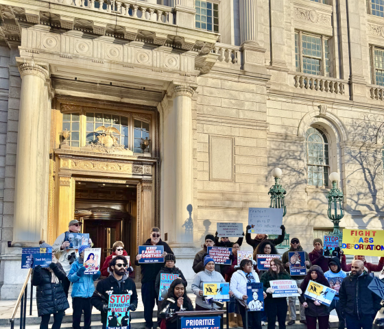 In front of the Capitol, the Trust Act Coalition stands on the steps together, rallying with folks.